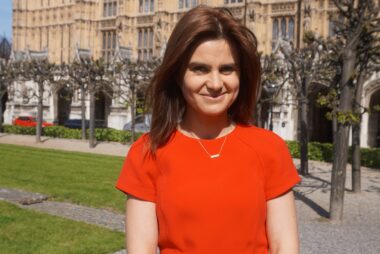 Photo of Jo Cox MP in front of Parliament.