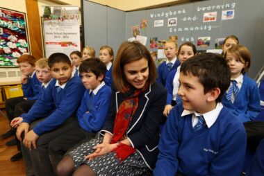 Jo Cox sat with school children.