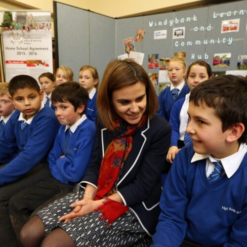 Jo Cox sat with school children.