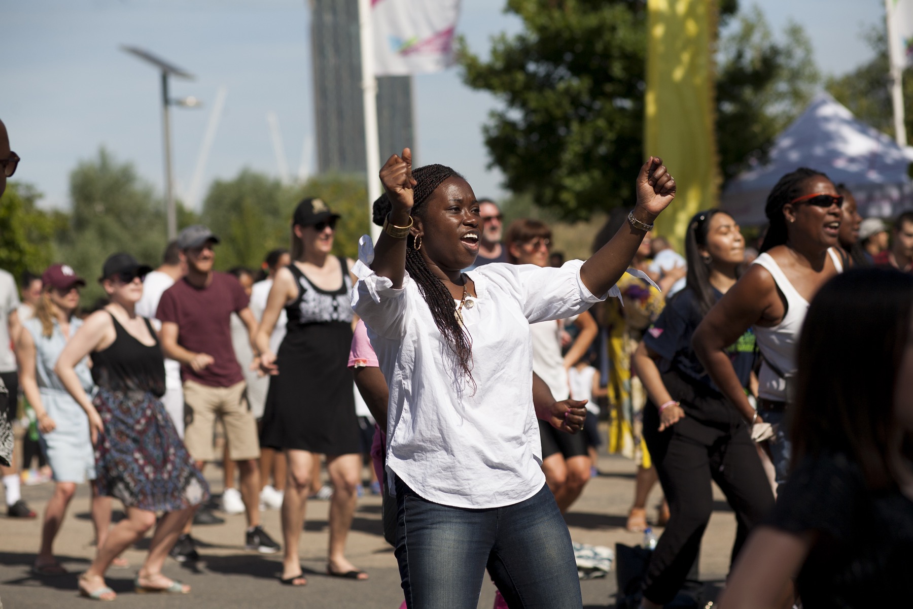 A person dancing in a crowd at a Great Get Together event in London.